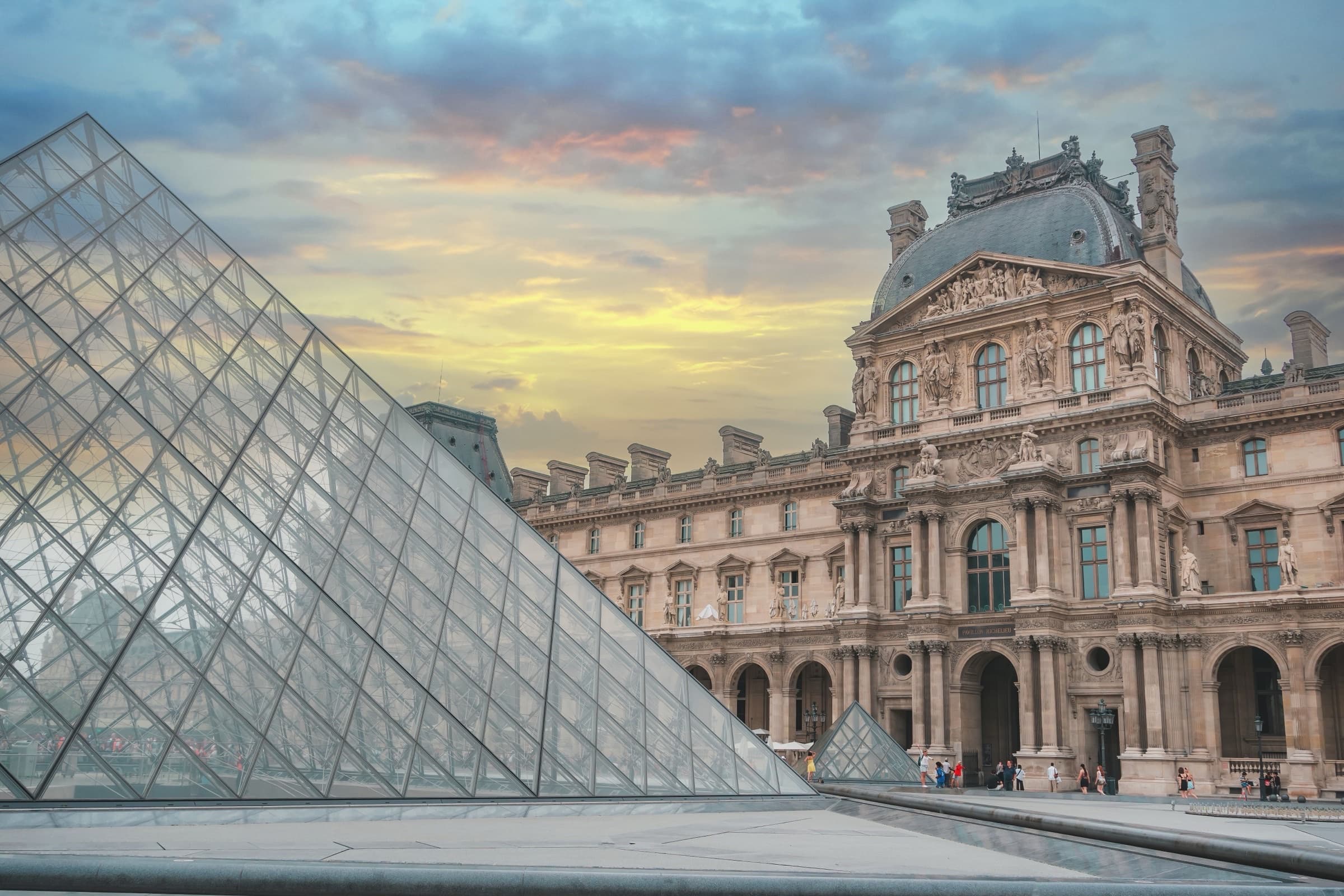 The Louvre Pyramid at dusk — modern architecture meeting classical structure